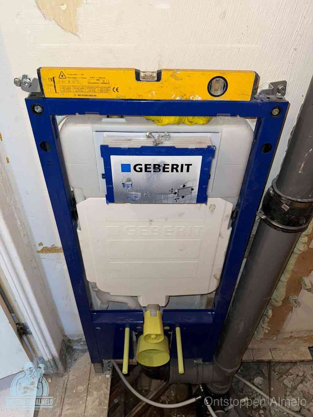 Een Geberit inbouwreservoir met frame voor een hangtoilet tegen de wand, met de afvoerbocht naar de vloer, kenmerkend voor een verstopt hangtoilet in Almelo